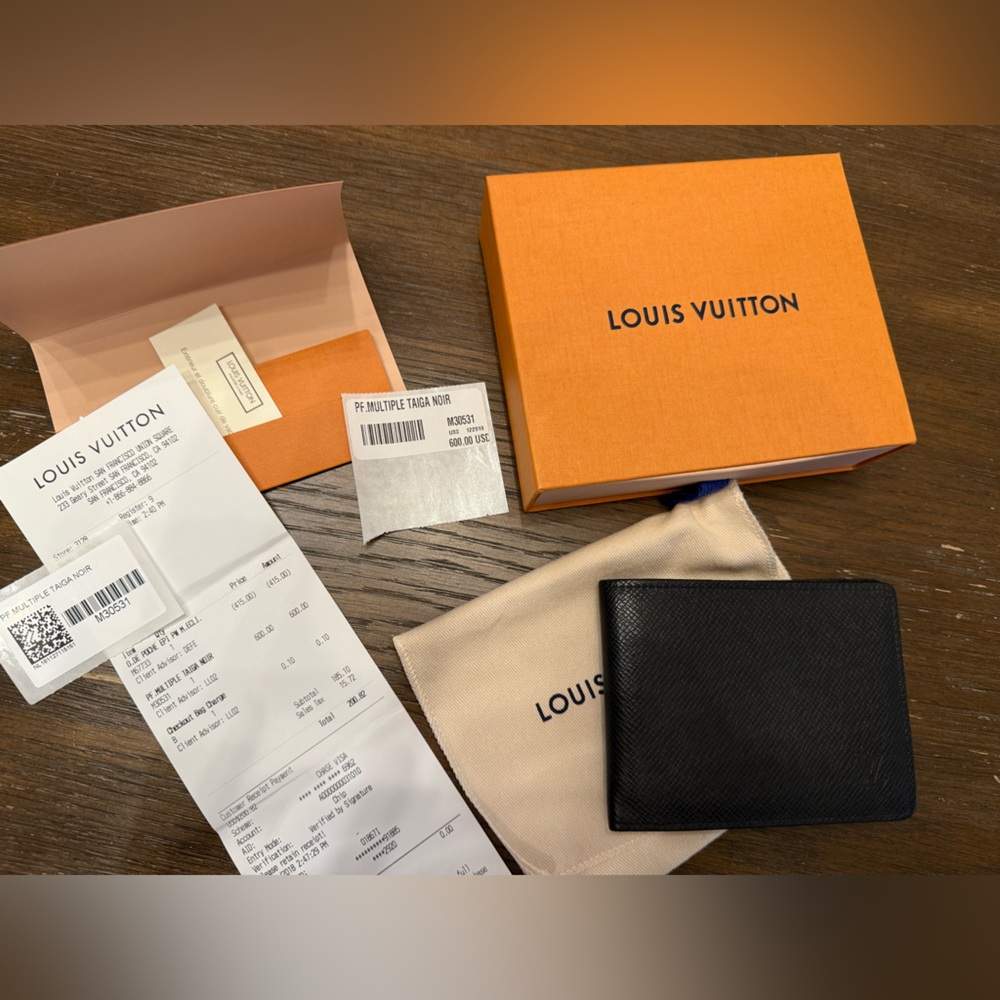 Authentic Louis Vuitton multiple wallet in Taiga Noir w/ receipt, jacket, & box